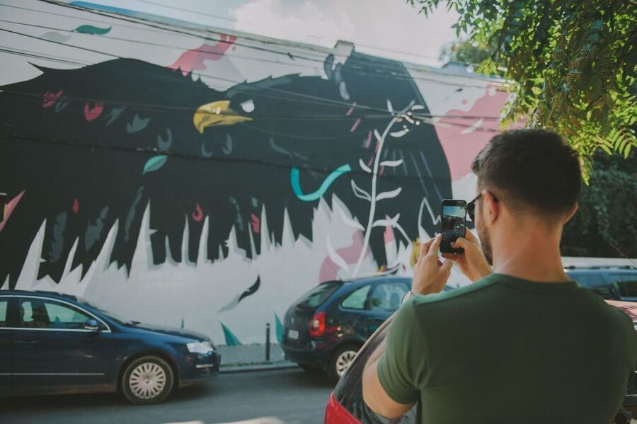 Bucharest Alternative Walking Tour - The restored Square Cat mural and Cinema Capitol Garden